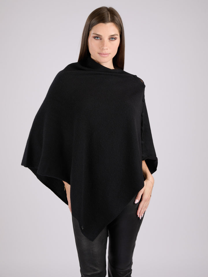 Cashmere knit poncho with  decorative cashmere covered buttons along one edge #BLACK