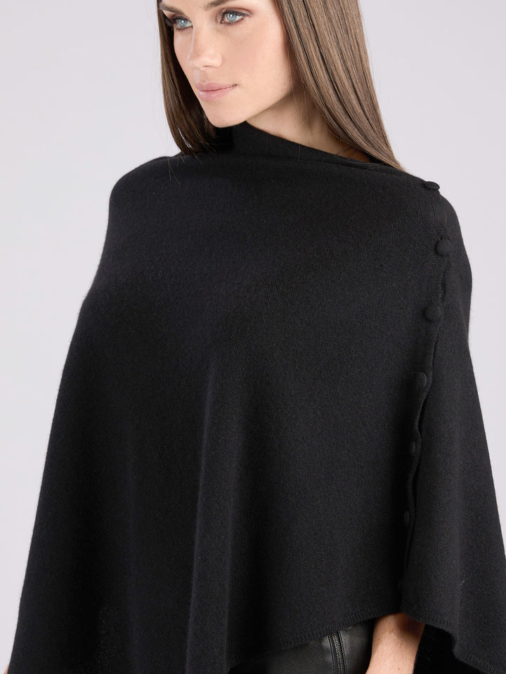 Cashmere knit poncho with  decorative cashmere covered buttons along one edge #BLACK