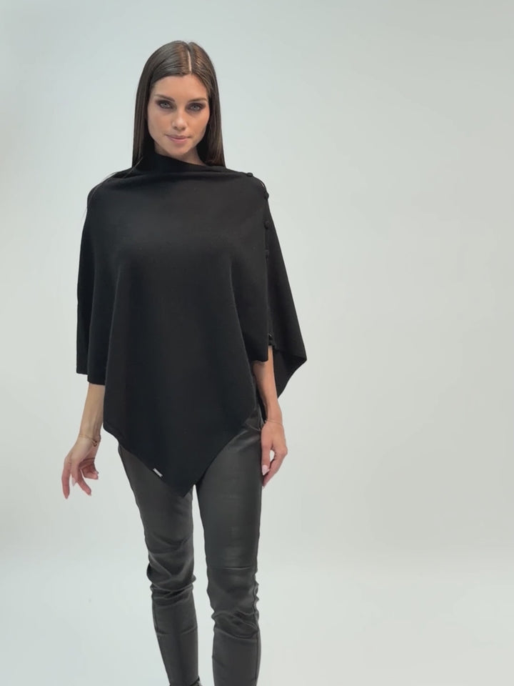 Cashmere knit poncho with  decorative cashmere covered buttons along one edge #BLACK